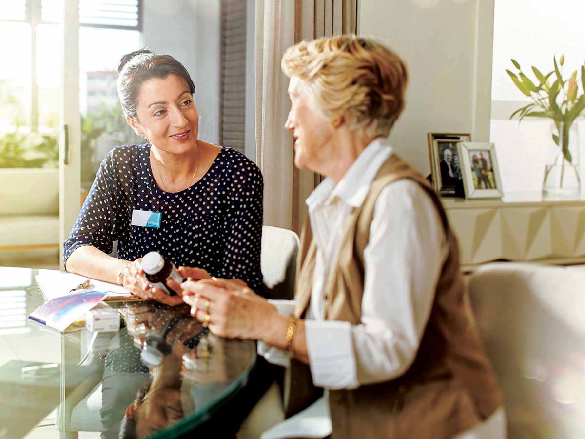 Village Nurse discussing medication with resident