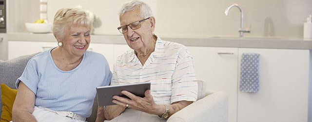 aveo newstead aged care couple looking at tablet