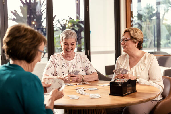 Ladies playing card game at the table