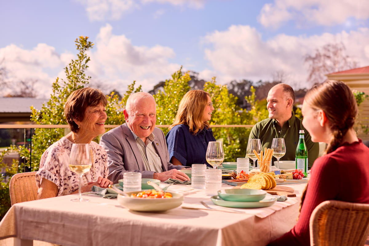 Residents outside on balcony having a lunch with their family5