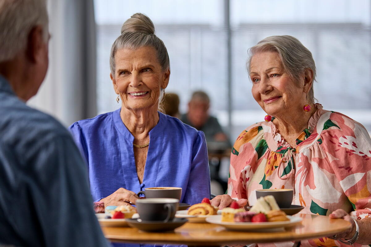 Residents in community cafe having coffee and chatting at table7